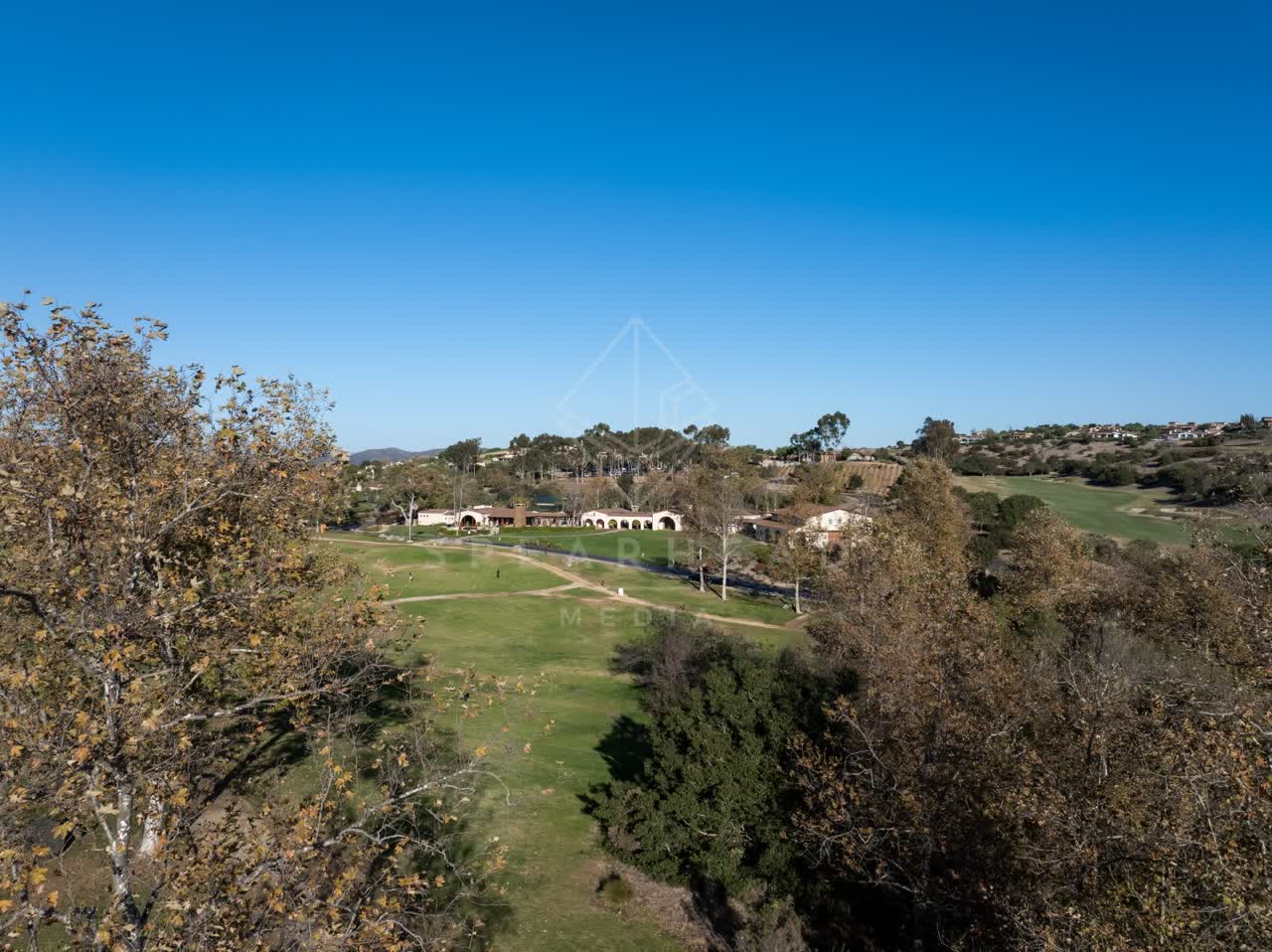Low aerial view of the country inland, homes and the buildings in Santaluz.