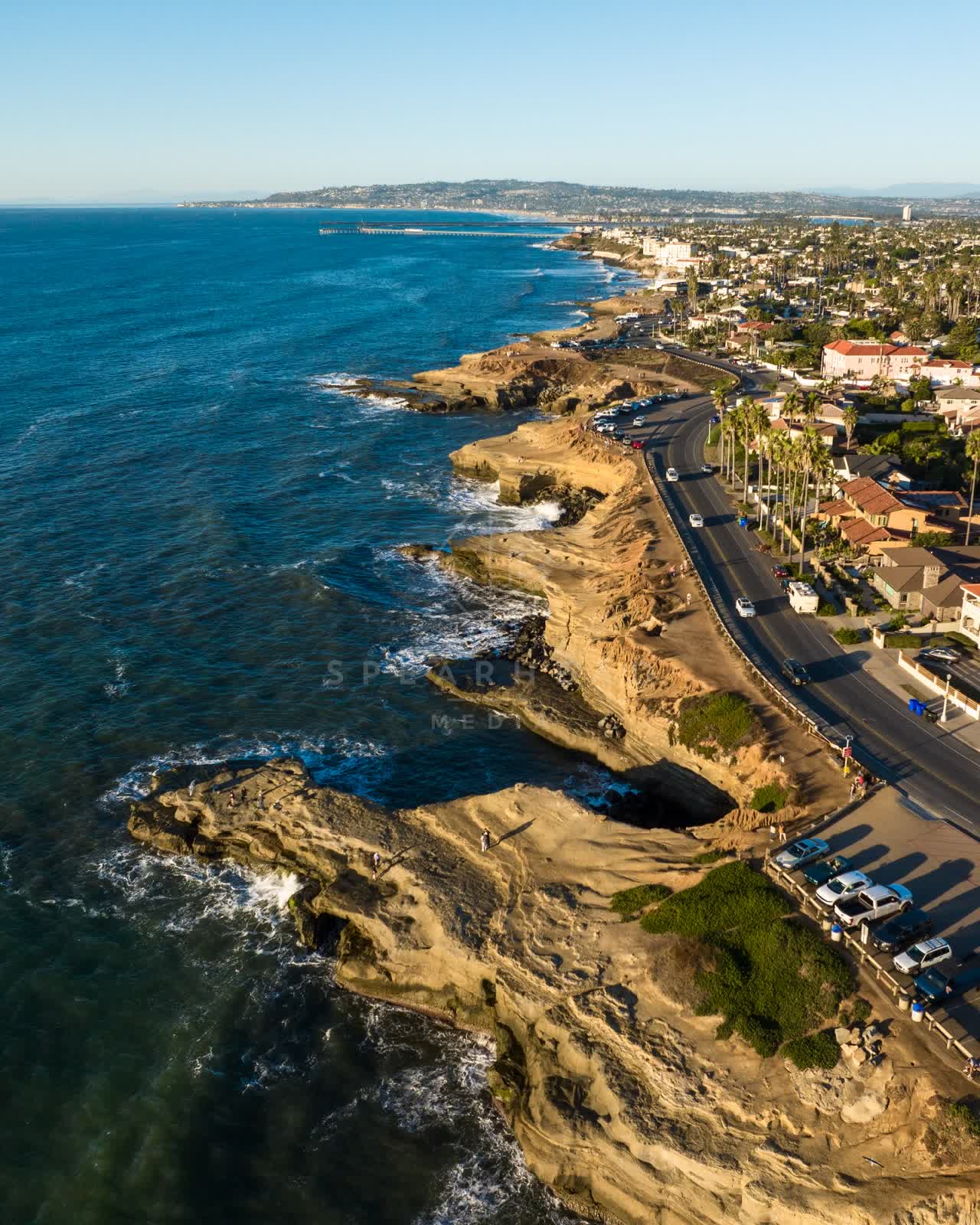 Aerial view of the cliffs, the pier and palm trees at Sunset Cliffs.