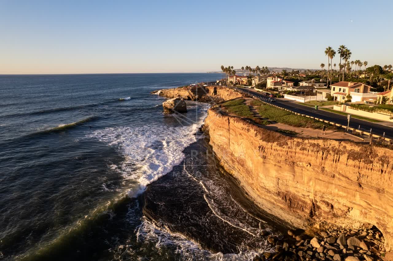 Aerial view of the cliffs, the surf and palm trees at Sunset Cliffs.