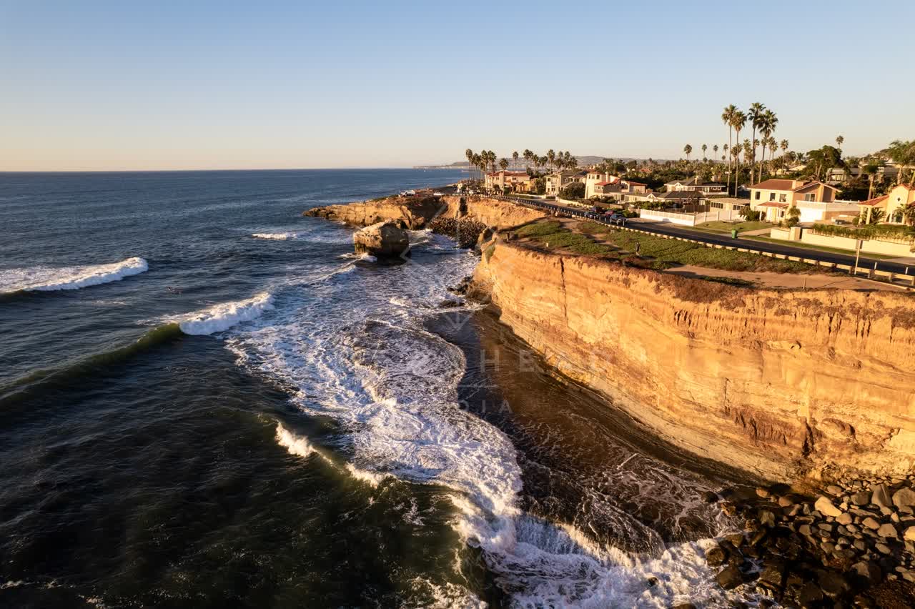 Aerial view of the cliffs, the surf and palm trees at Sunset Cliffs.