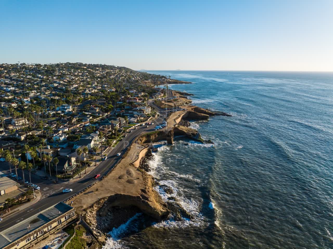 Aerial view of the cliffs, palm trees and the ocean at Sunset Cliffs.