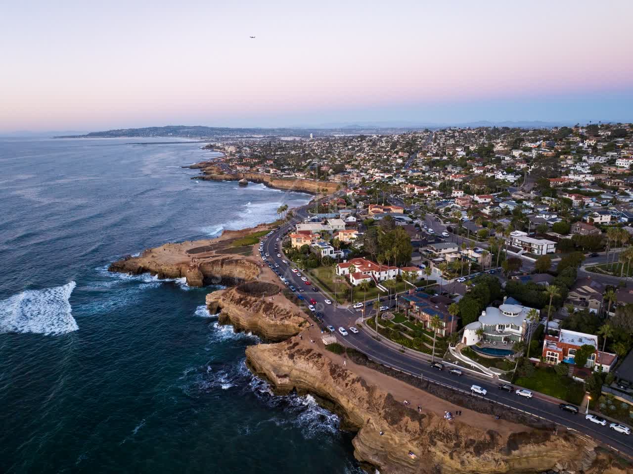 Aerial view of the cliffs, the surf and the ocean at Sunset Cliffs.