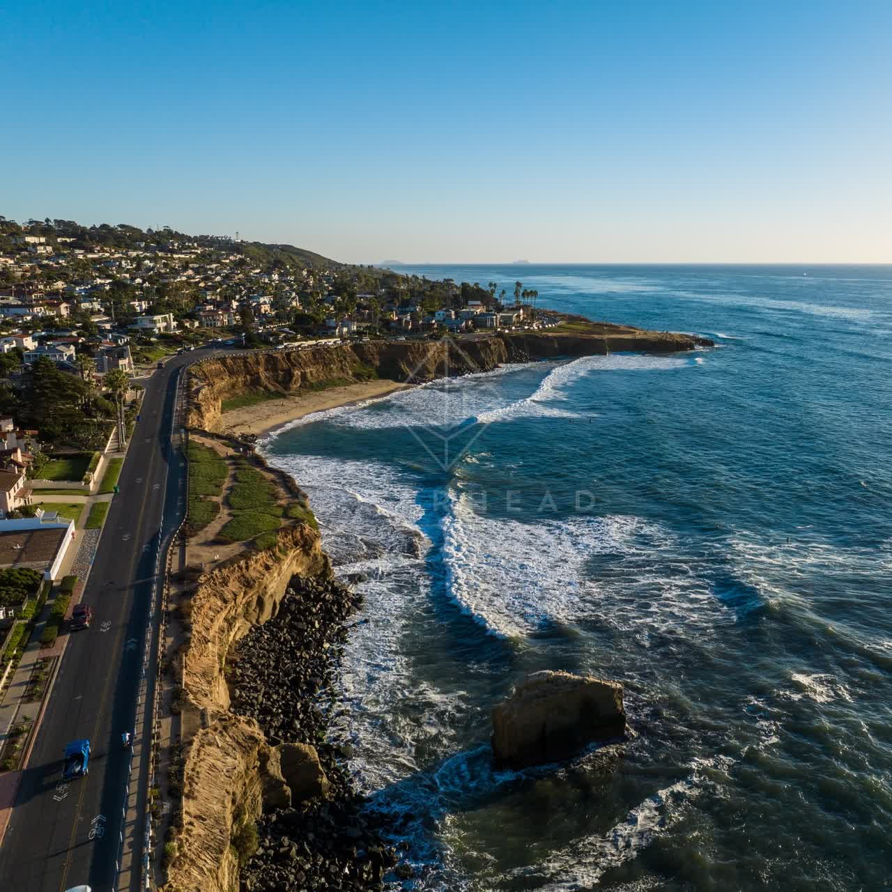 Aerial view of the cliffs, the surf and the ocean at Sunset Cliffs.