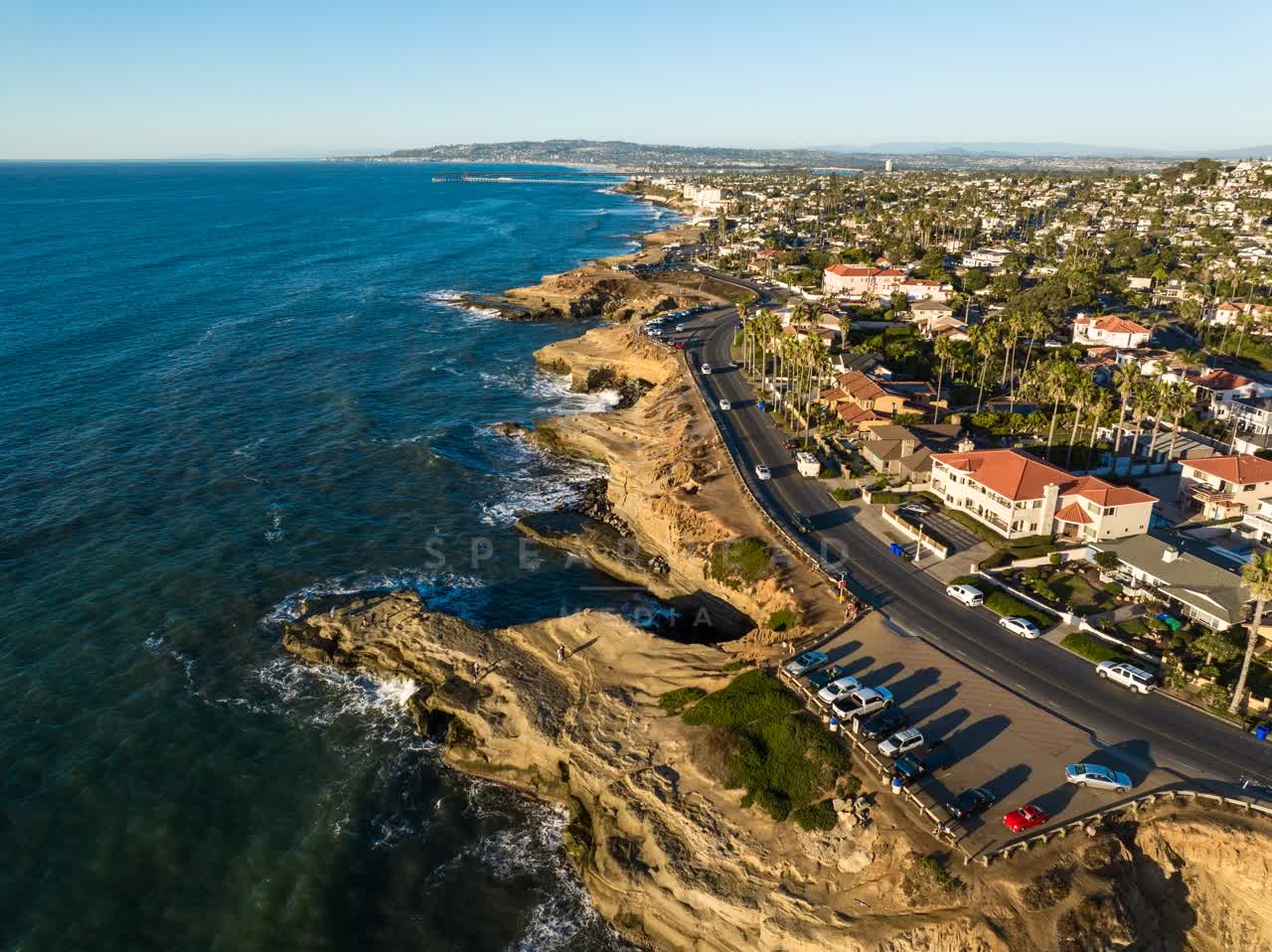 Aerial view of the cliffs, palm trees and the ocean at Sunset Cliffs.