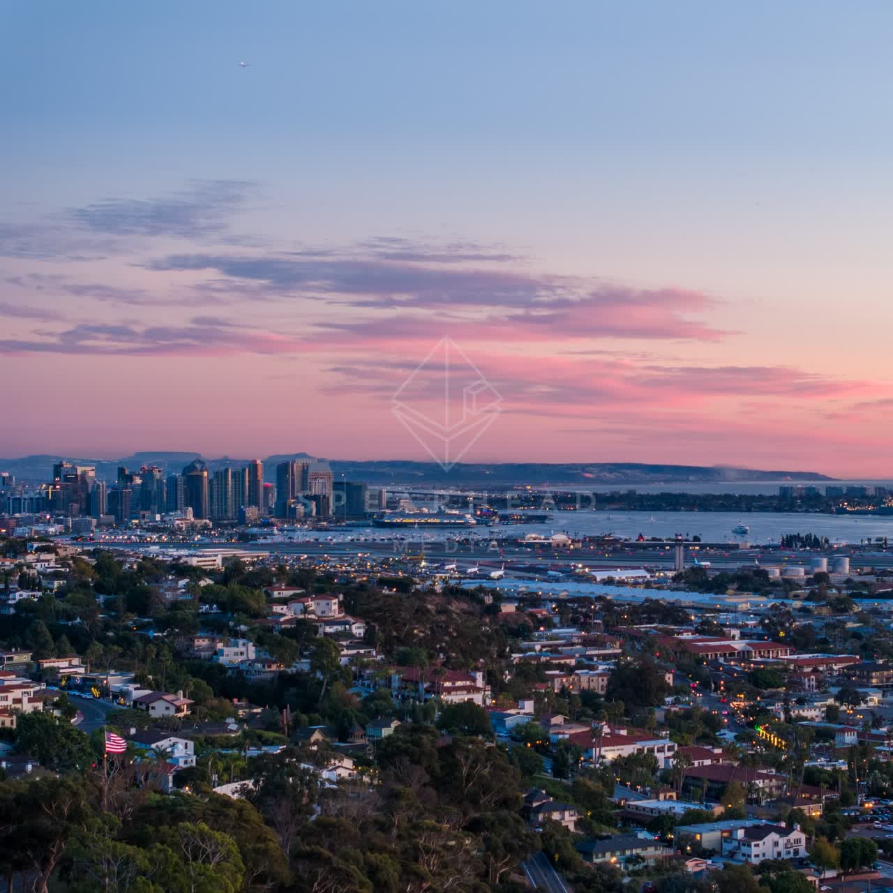 Aerial view of a residential street, the skyline and boats in Downtown San Diego.