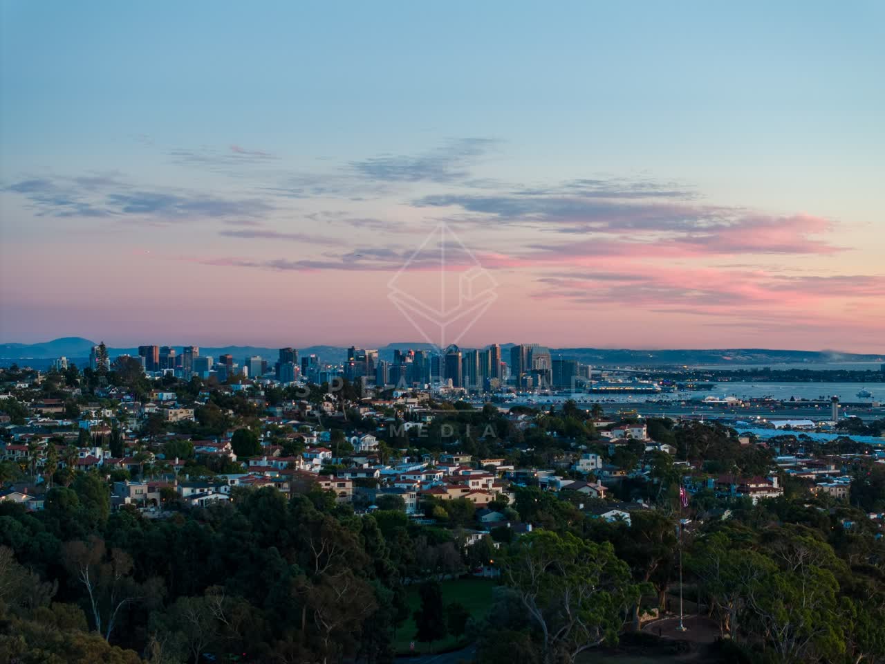Aerial view of a residential street, the skyline and boats in Downtown San Diego.