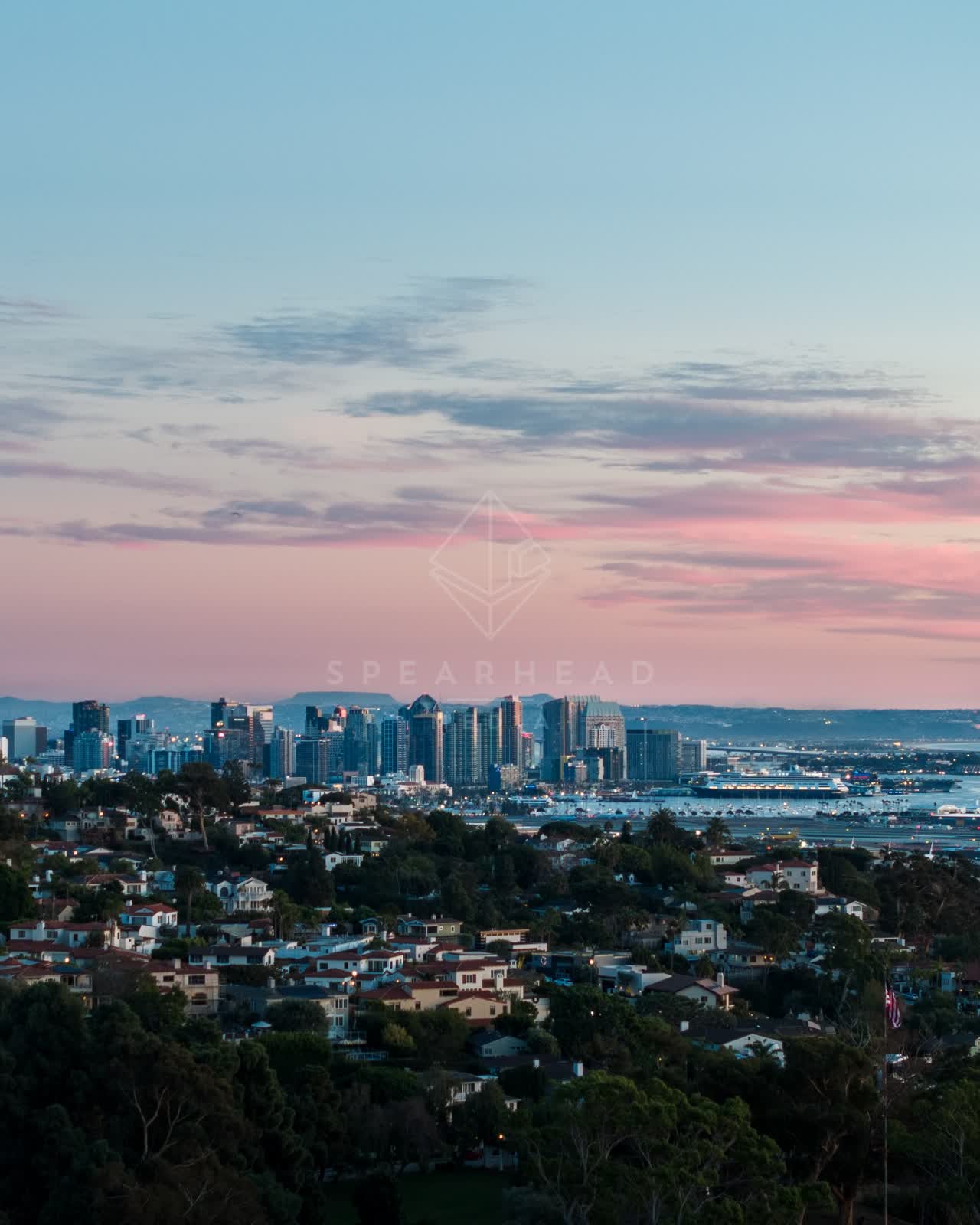 Elevated view of a residential street, the skyline and boats in Downtown San Diego.