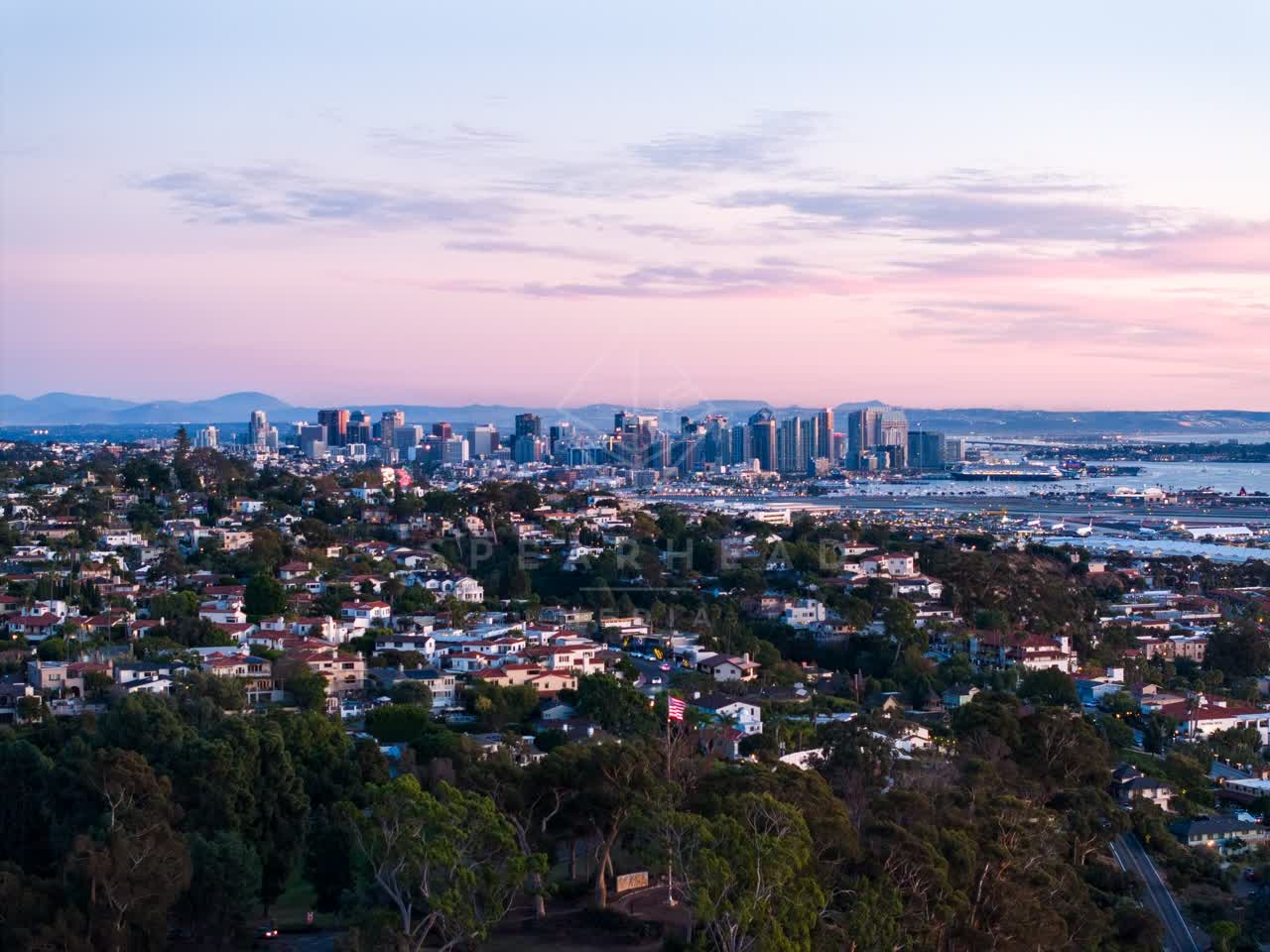 Aerial view of a residential street, the skyline and boats in Downtown San Diego.