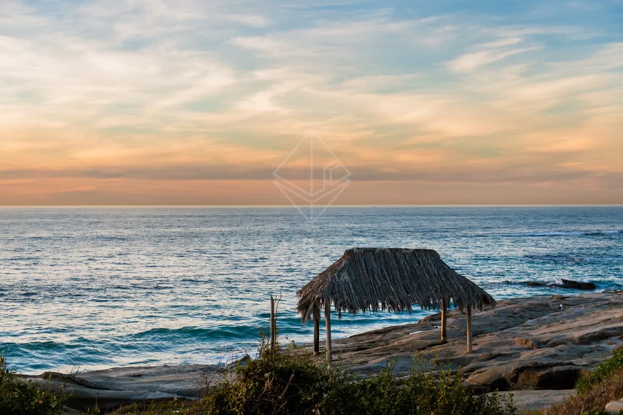 Elevated view of the cliffs, the surf and the ocean at Windansea.