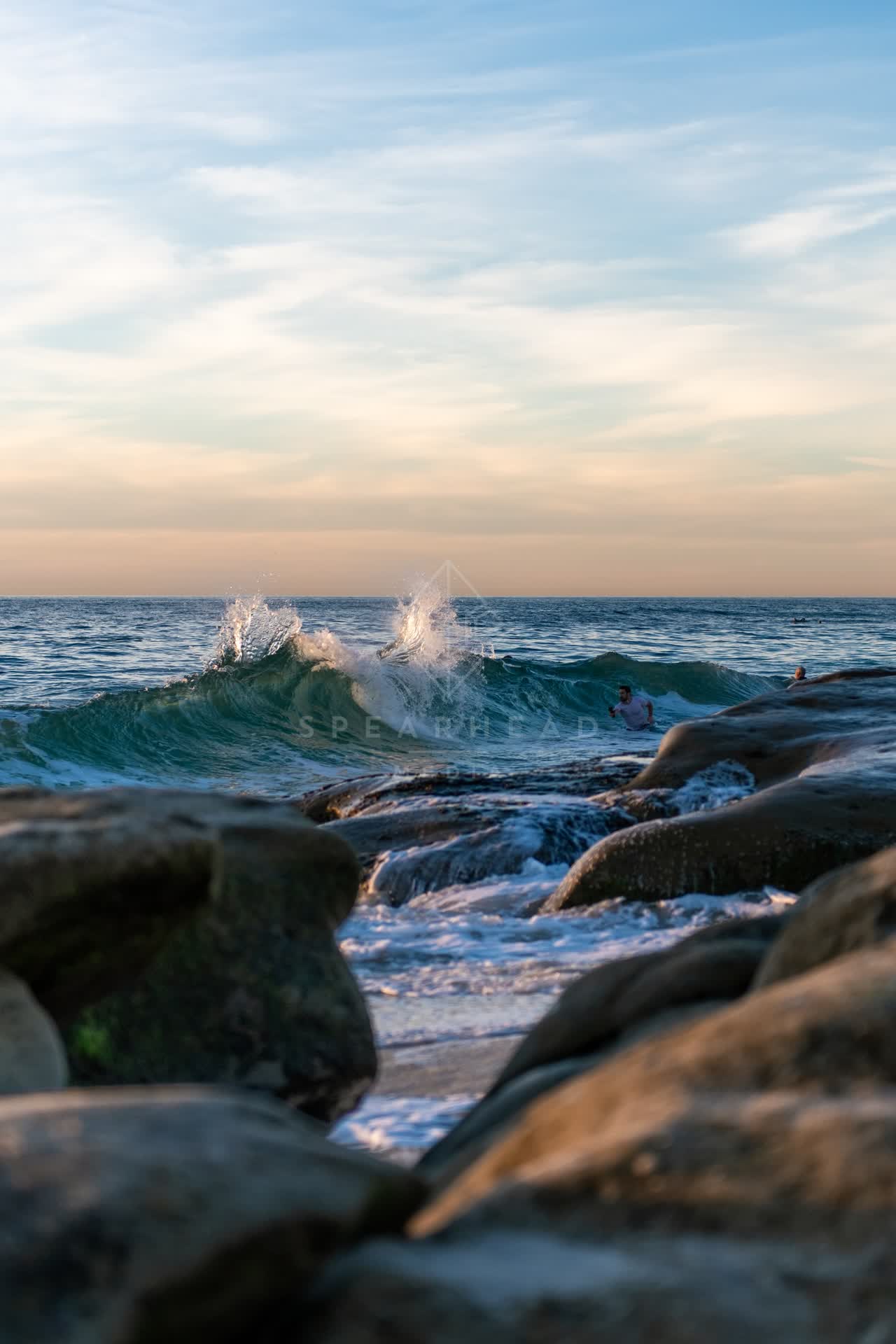 The beach, the surf and the ocean at Windansea, with swimmers in the water.