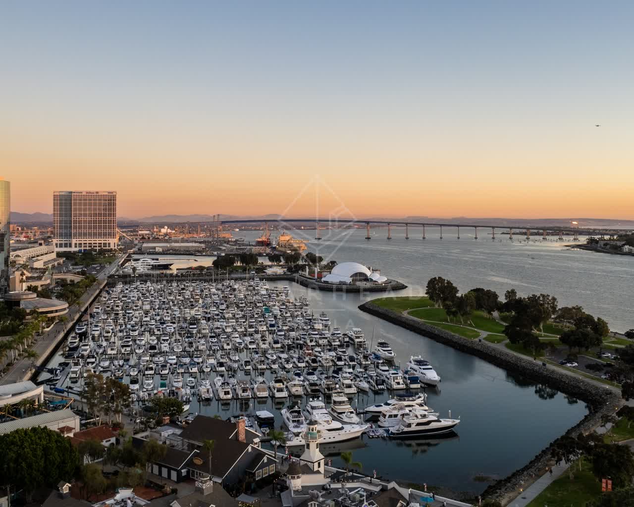 Aerial view of the harbor, the bridge and boats at San Diego Marina, with boats out.