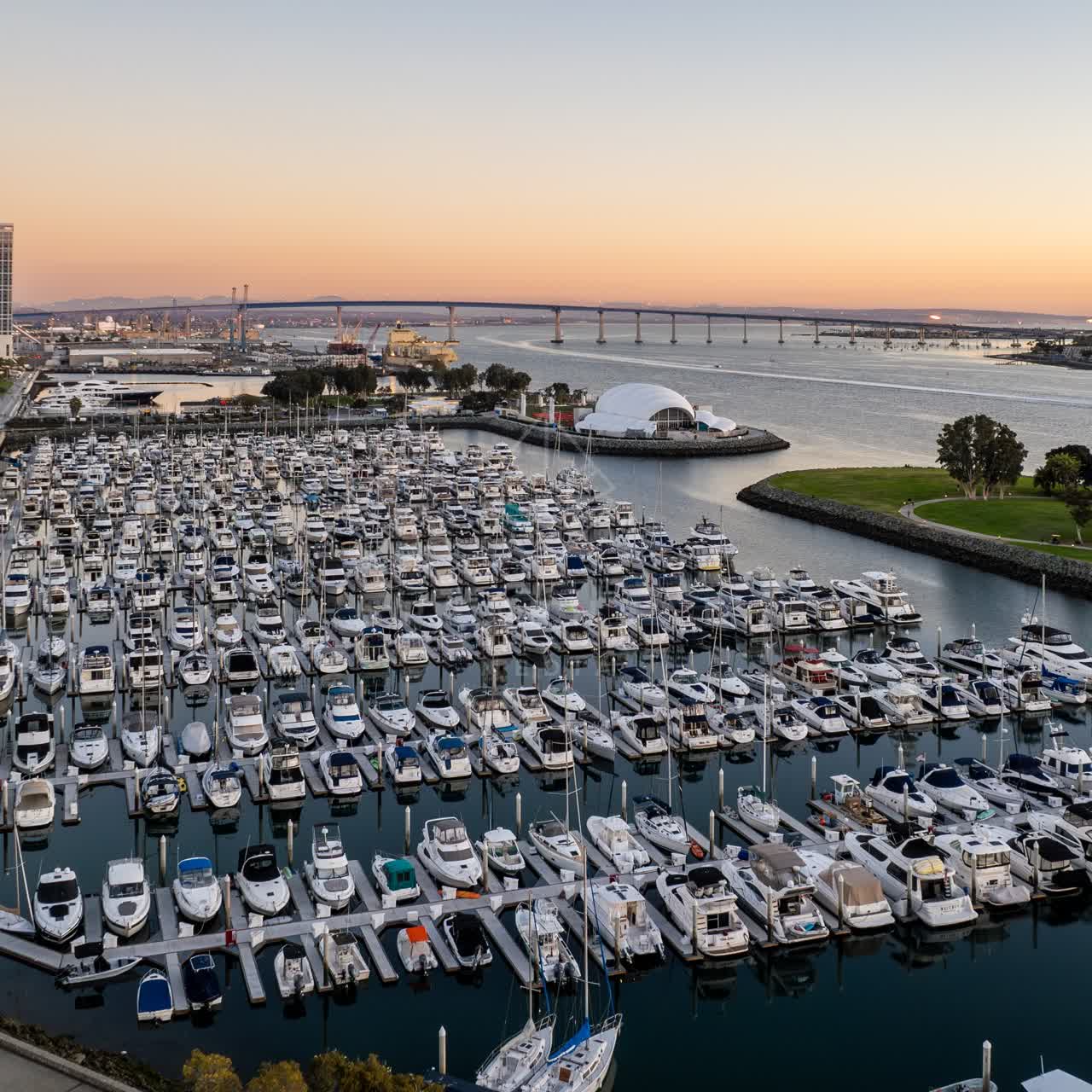 Aerial view of the harbor, the bridge and boats at San Diego Marina, with boats out.