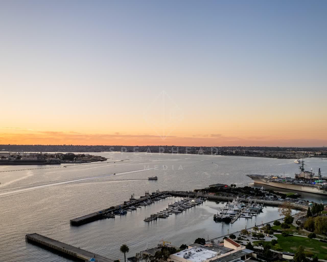 Aerial view of the harbor, the pier and boats at San Diego Marina, with boats out.
