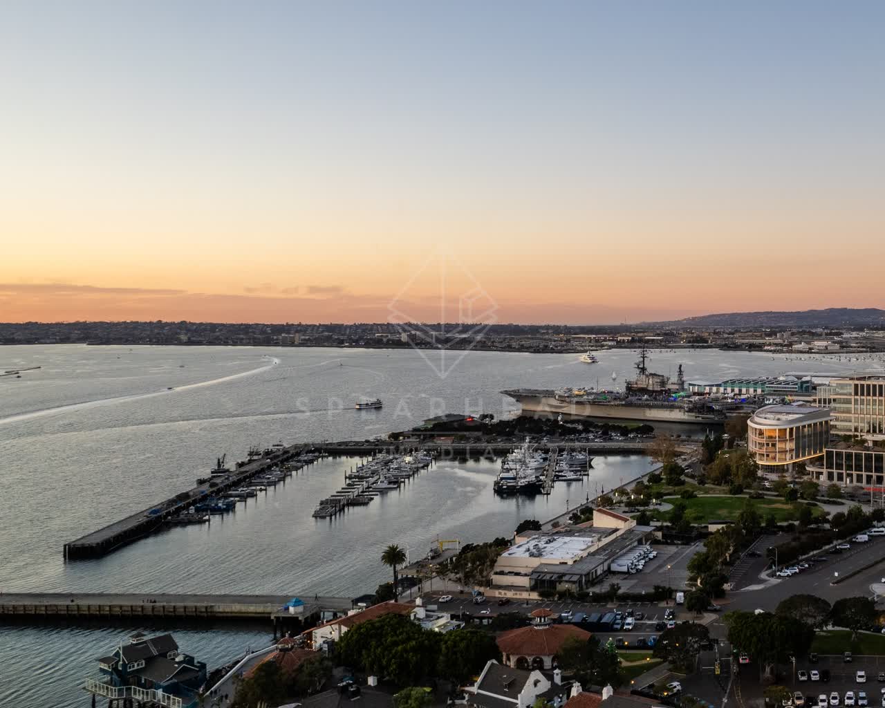 Aerial view of the harbor, the pier and boats at San Diego Marina, with boats out.