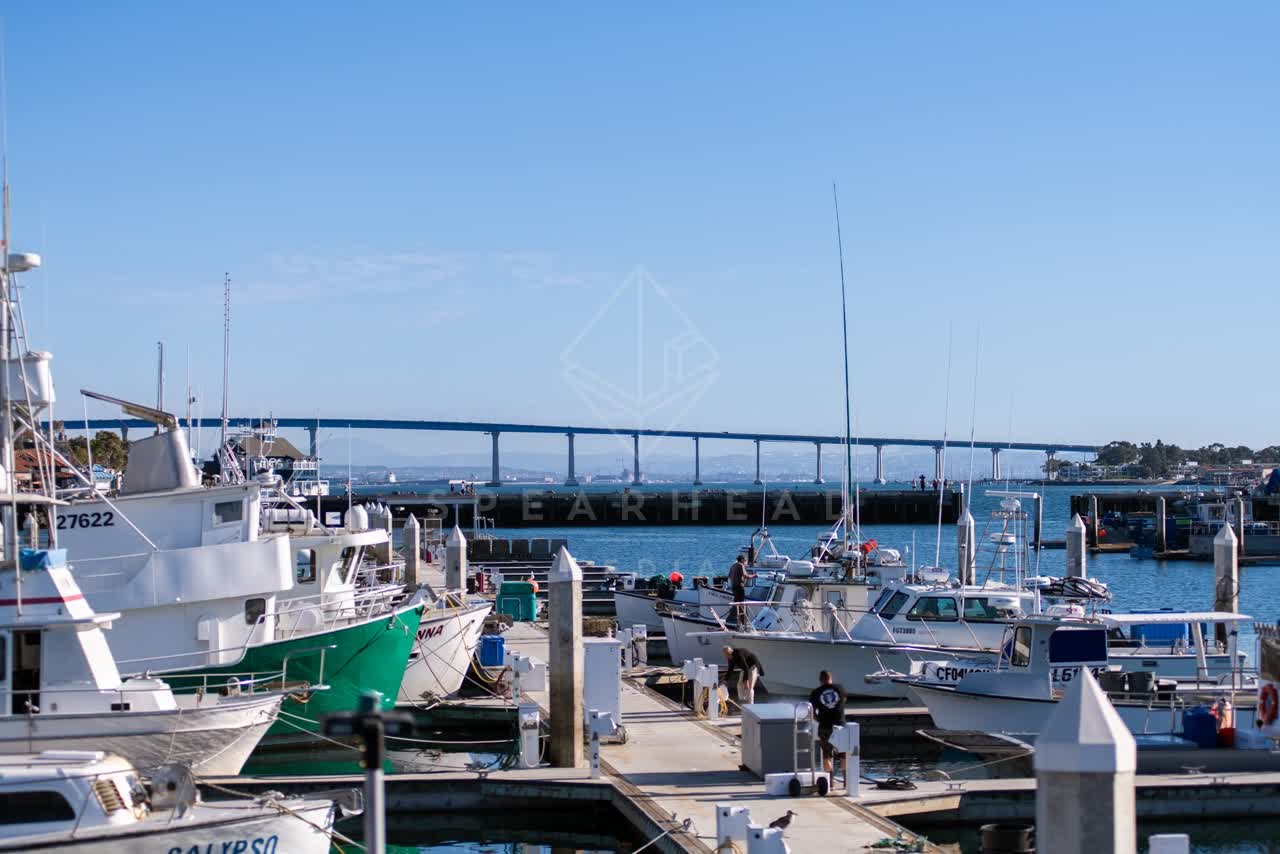 Elevated view of the harbor, the bridge and boats at Embarcadero, with a work crew on site.