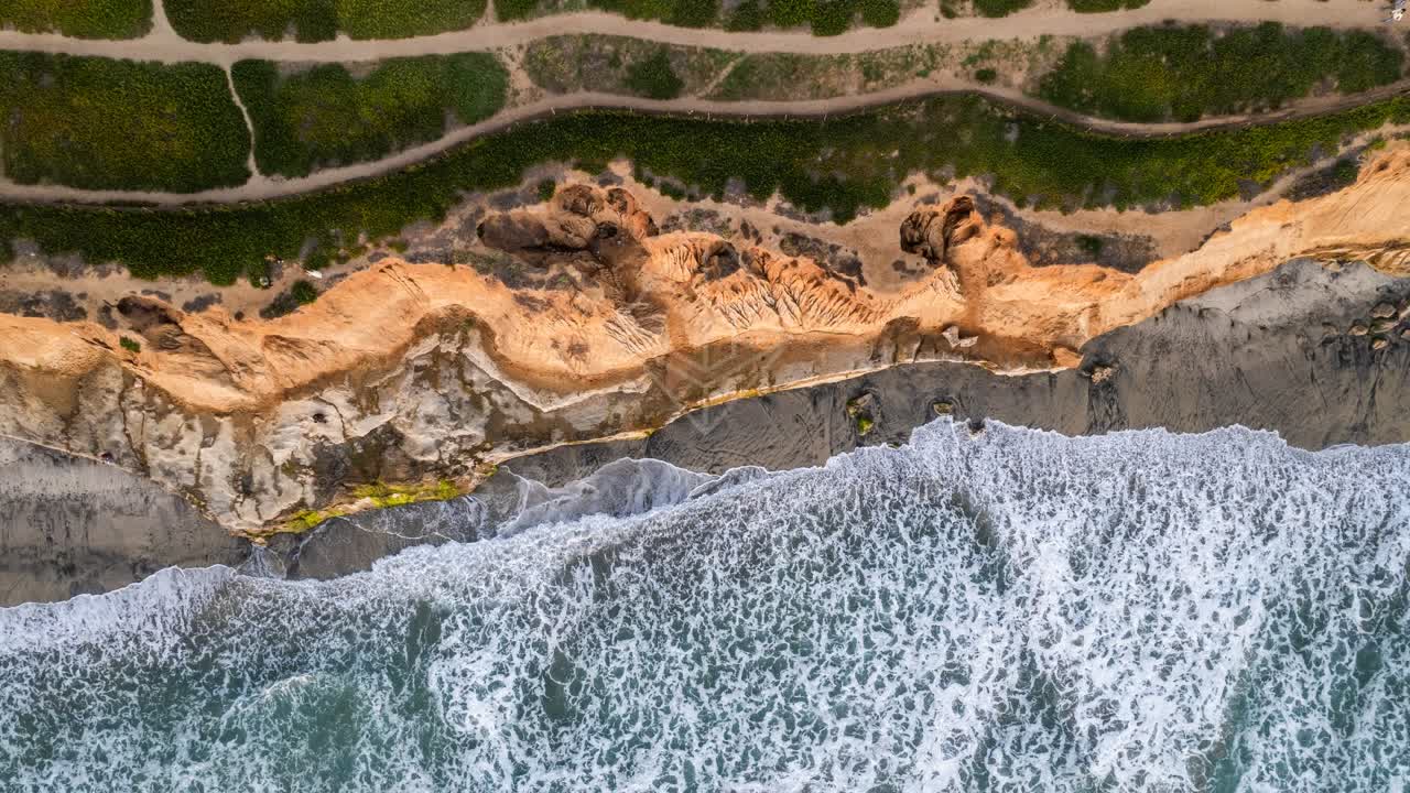 Aerial view of the cliffs, the surf and the ocean at Terramar Beach.
