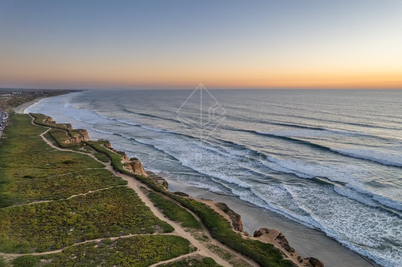 Aerial view of the cliffs, the surf and the ocean at Terramar Beach.