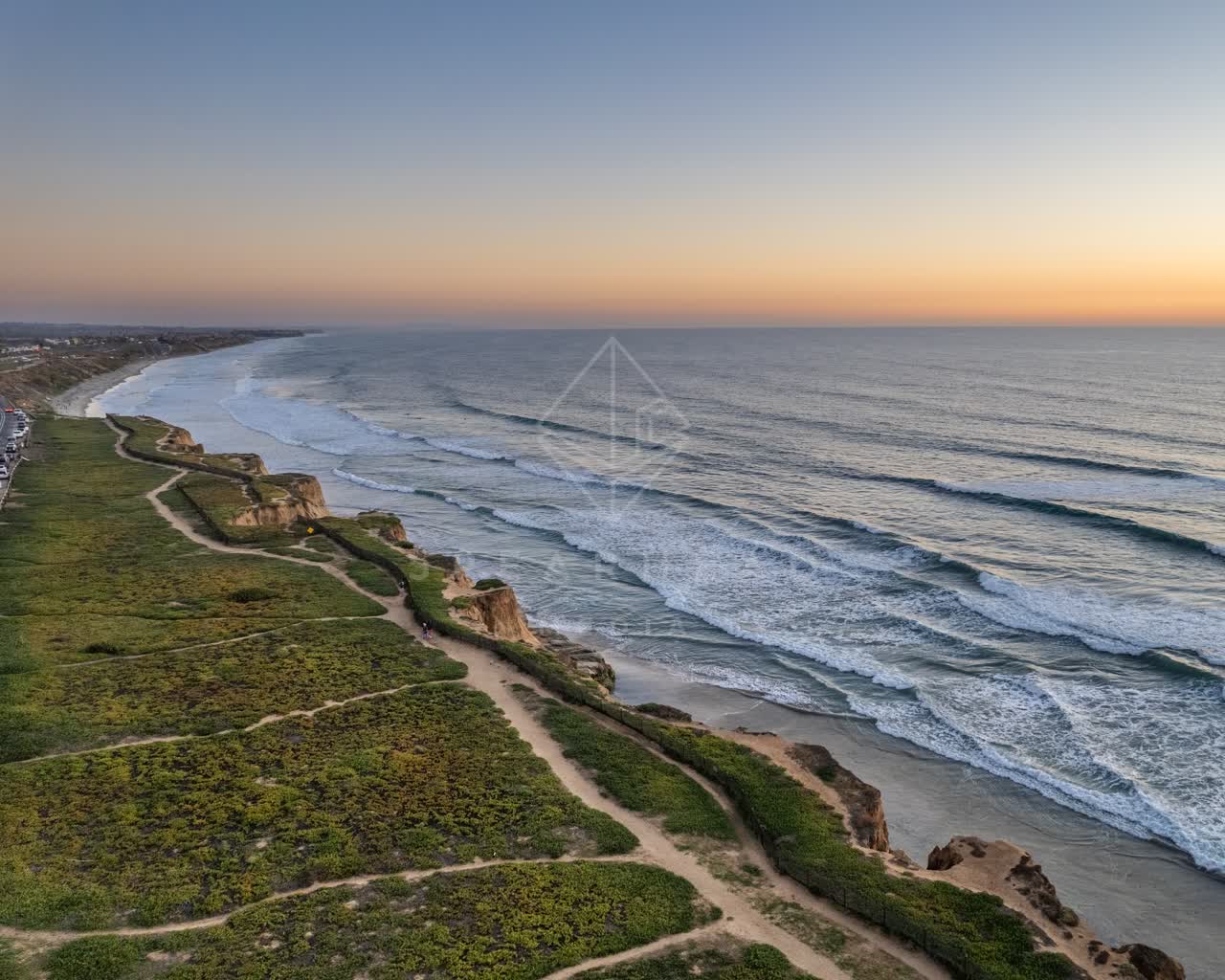 Aerial view of the cliffs, the surf and the ocean at Terramar Beach.