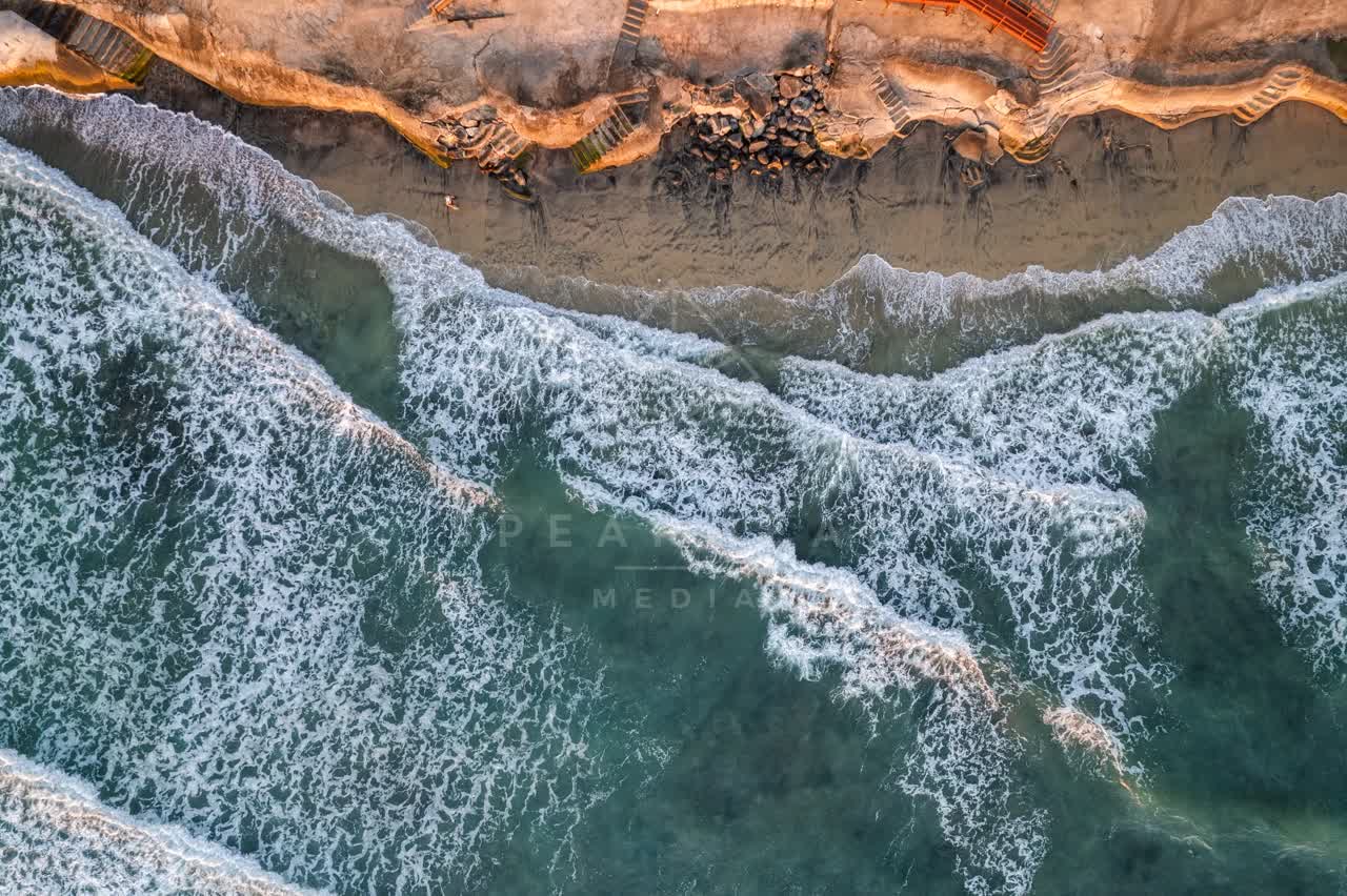 Aerial view of the beach, the surf and the ocean at Terramar Beach.