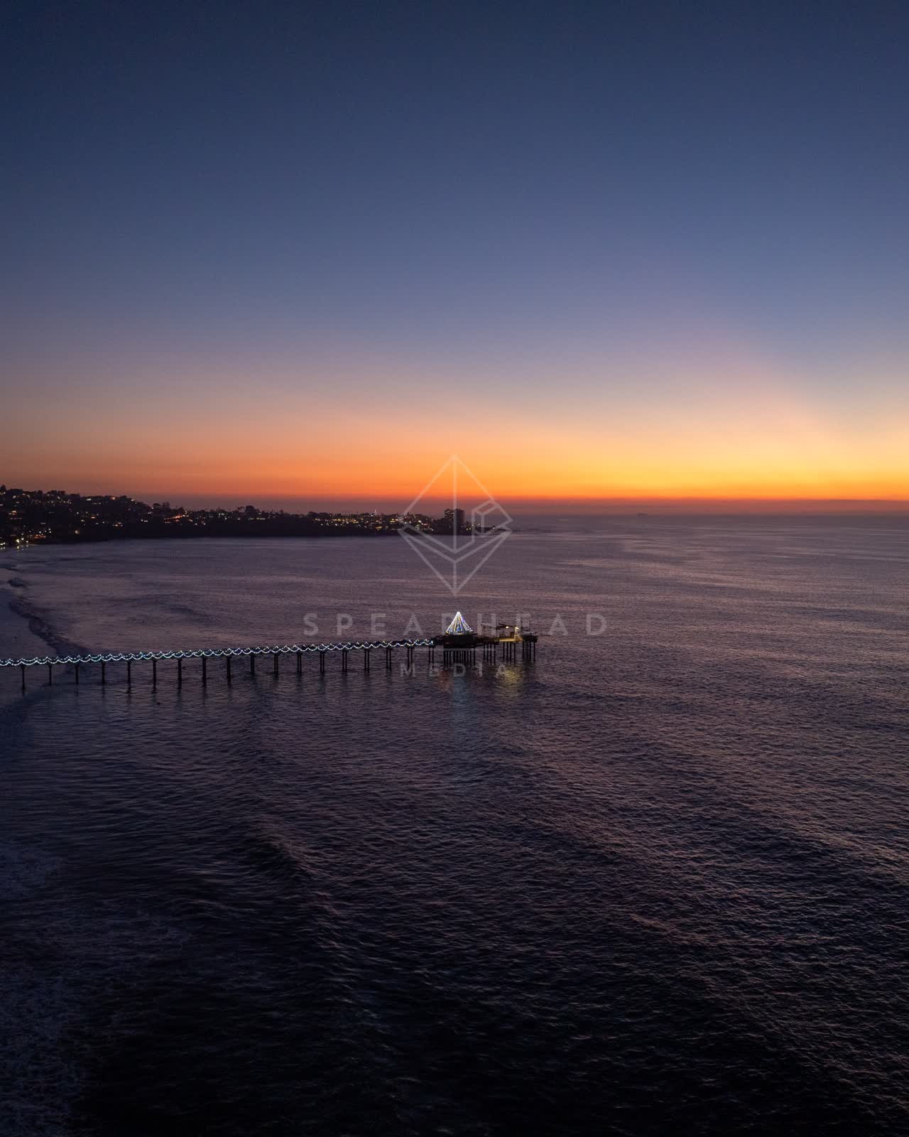 Aerial view of the beach, the pier and the ocean at La Jolla Shores.