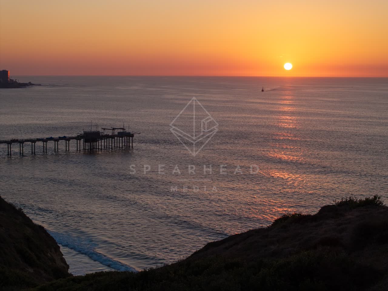Elevated view of the cliffs, the pier and the ocean at La Jolla Shores.