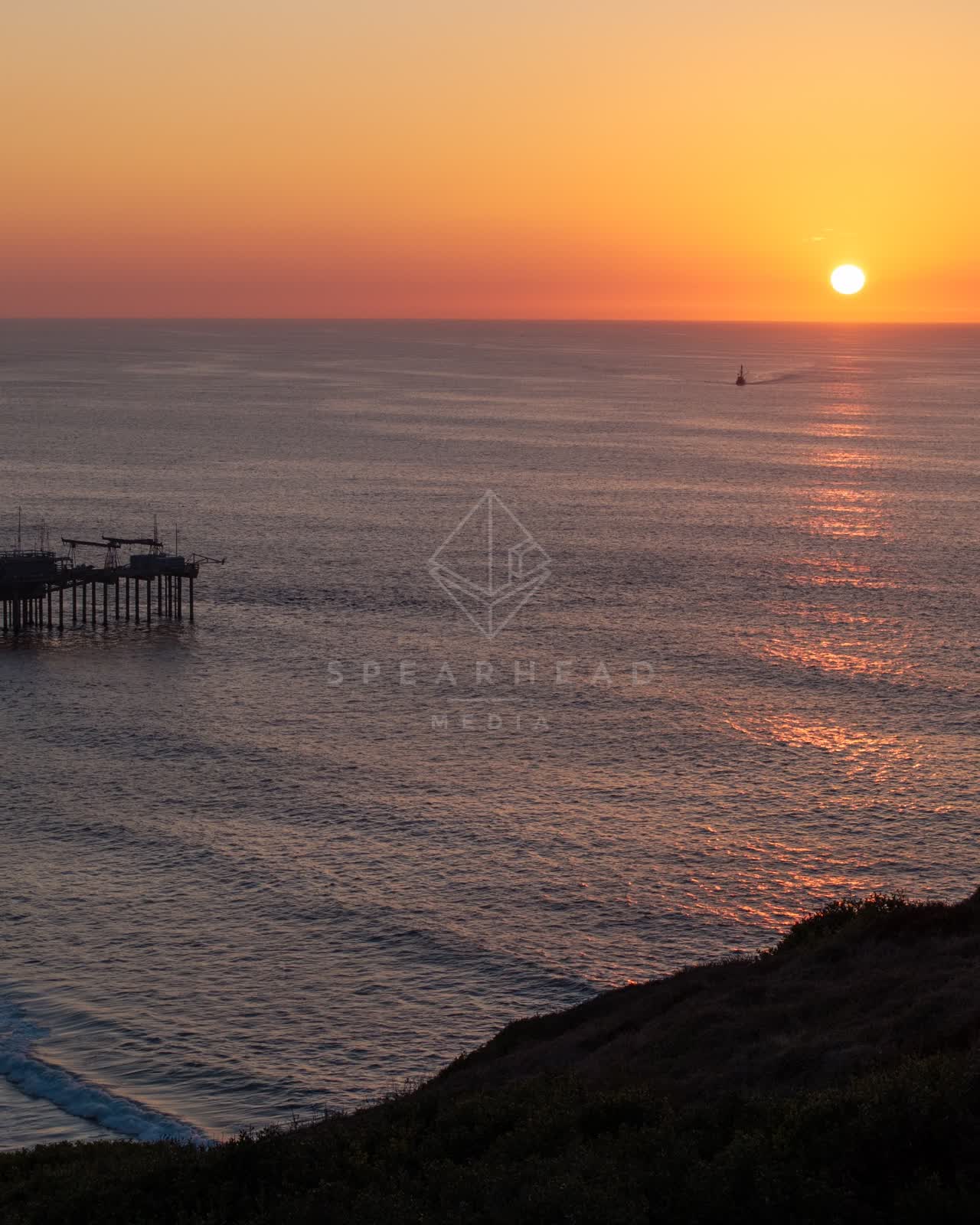 Elevated view of the cliffs, the pier and the ocean at La Jolla Shores.