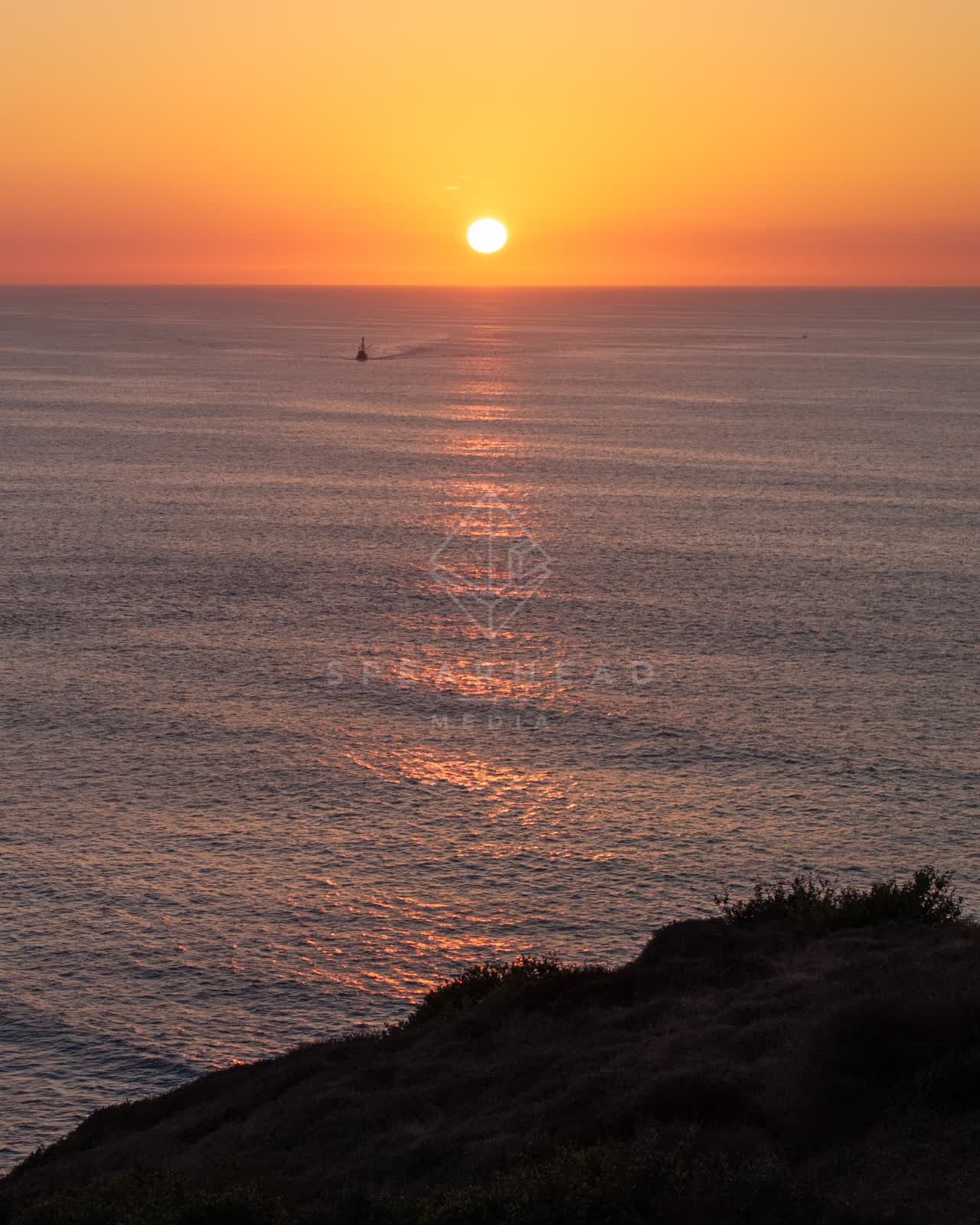 Elevated view of the cliffs, boats and the ocean at La Jolla Shores.