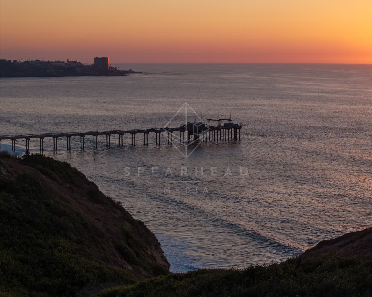 Elevated view of the cliffs, the pier and the ocean at La Jolla Shores.