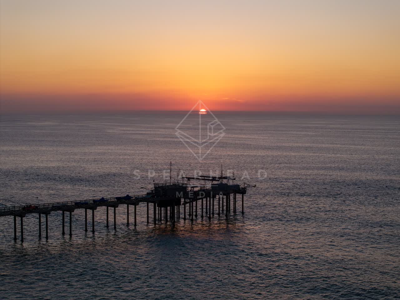 Low aerial view of the beach, the pier and the ocean at La Jolla Shores.