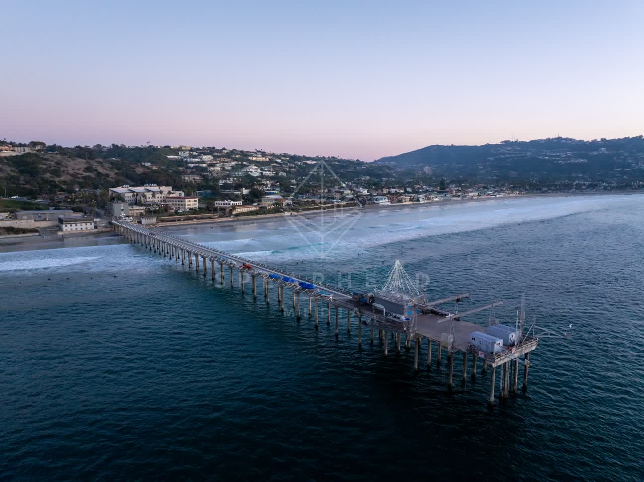 Aerial view of the beach, the surf and the pier at La Jolla Shores.