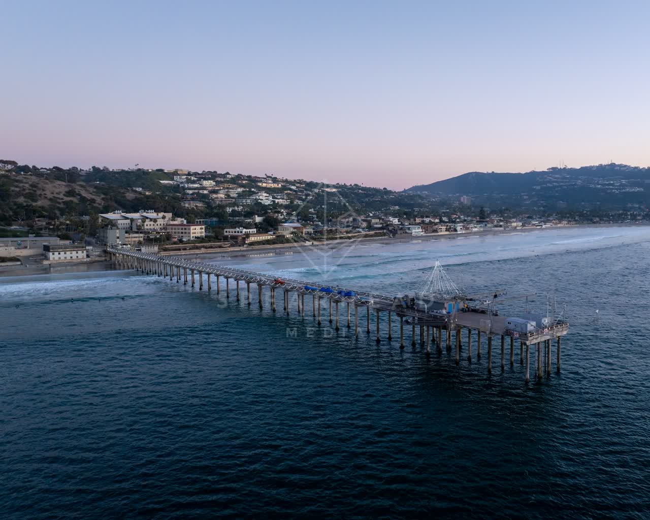 Aerial view of the beach, the surf and the pier at La Jolla Shores.