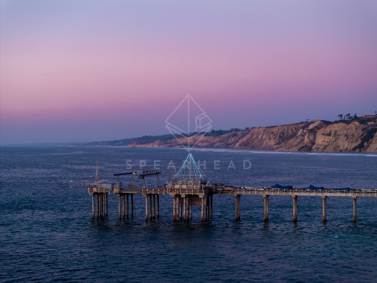 Low aerial view of the beach, the pier and the ocean at La Jolla Shores.