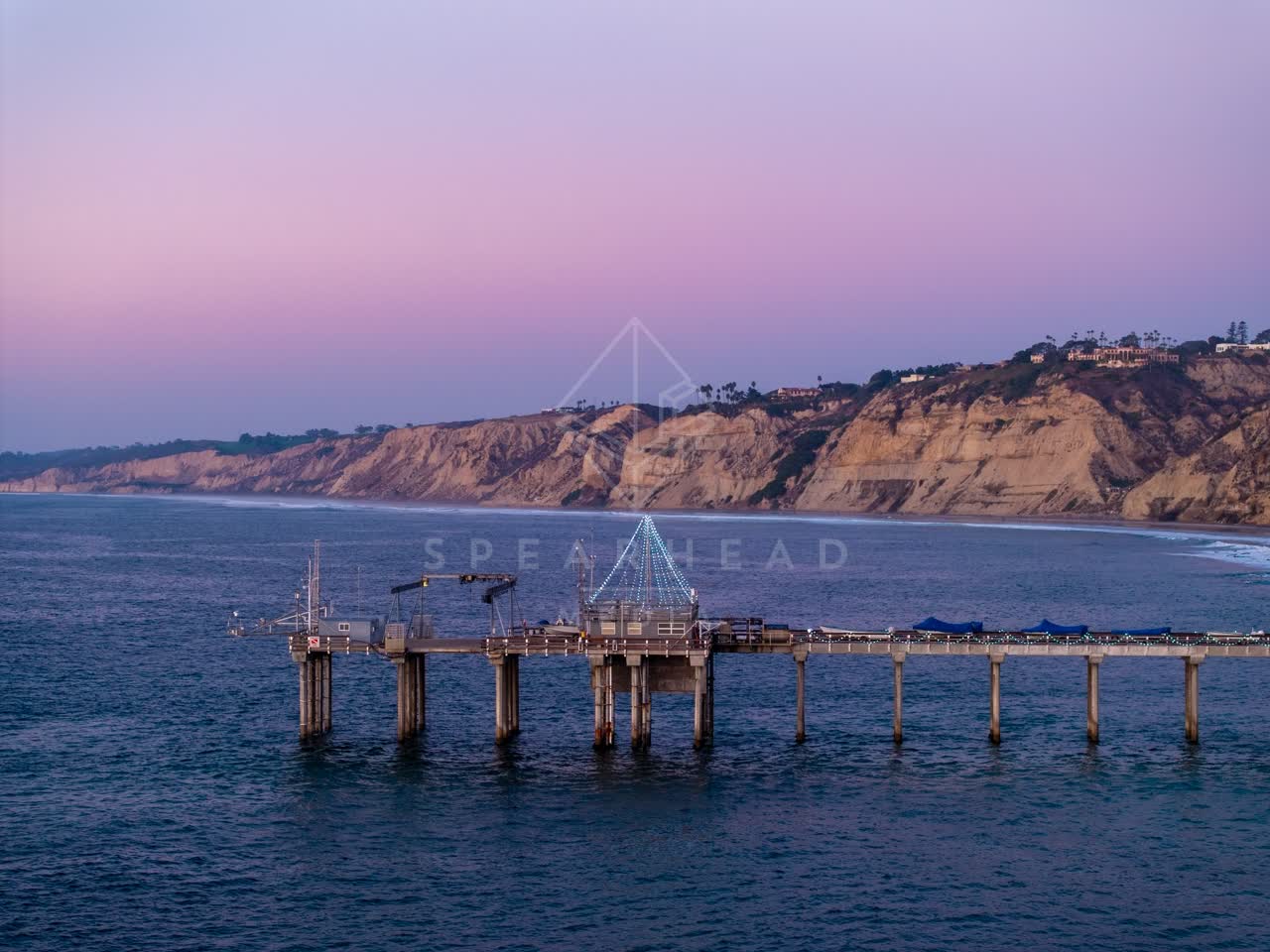 Low aerial view of the beach, the pier and the ocean at La Jolla Shores.