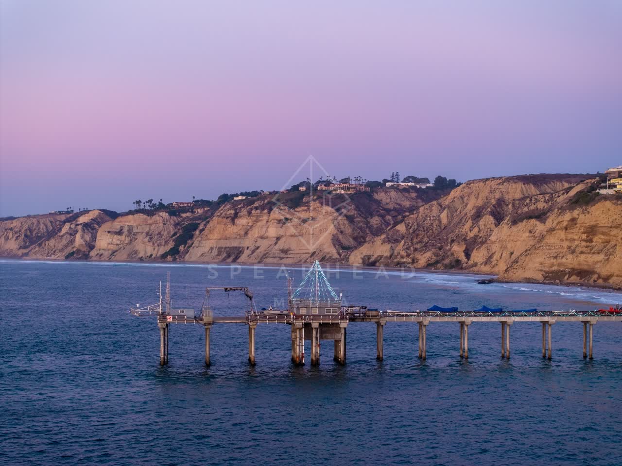 Low aerial view of the beach, the pier and the ocean at La Jolla Shores.