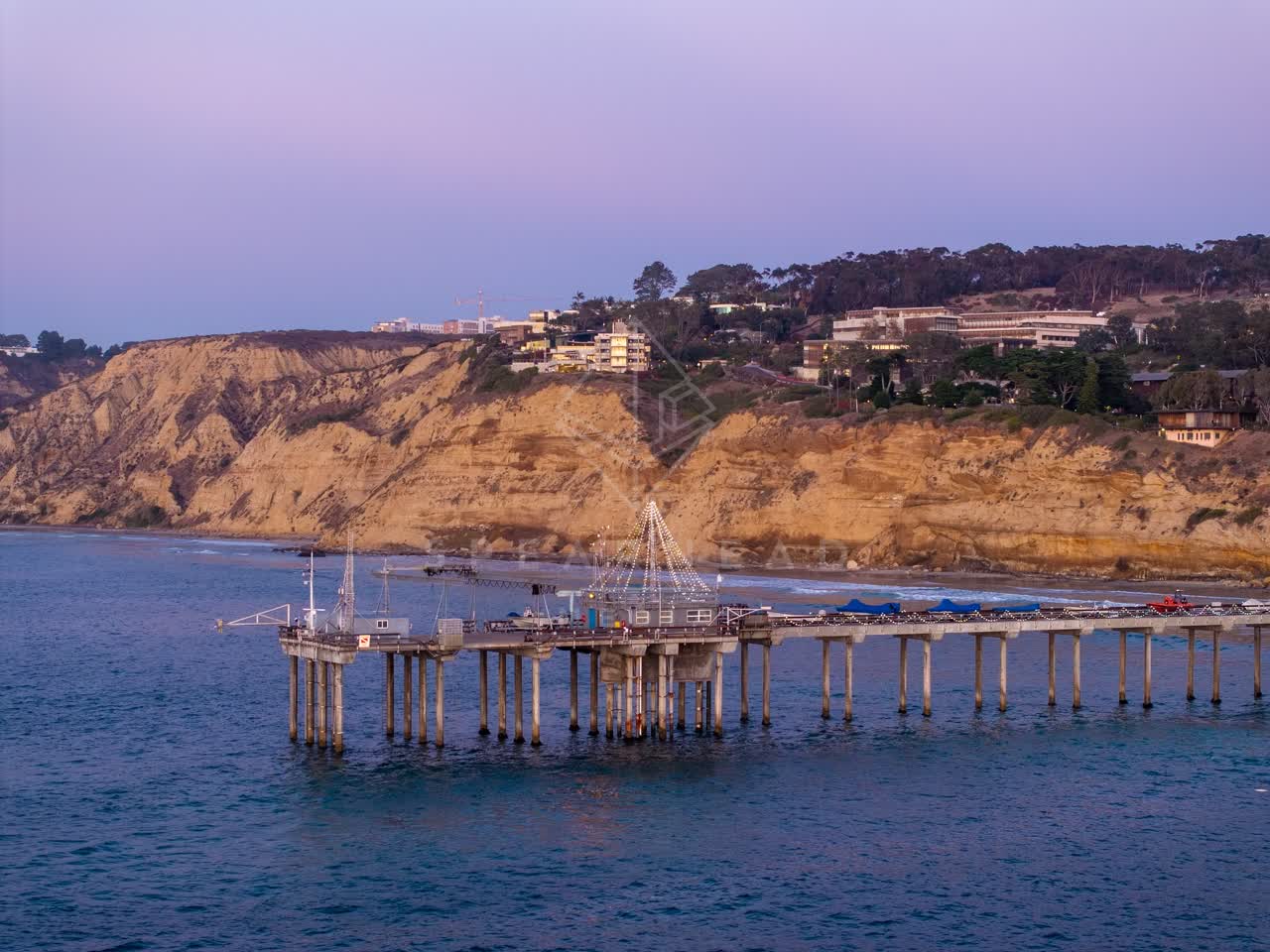 Low aerial view of the beach, the pier and the ocean at La Jolla Shores.