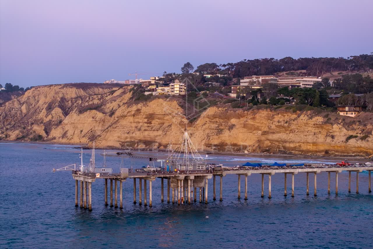 Low aerial view of the beach, the pier and the ocean at La Jolla Shores.
