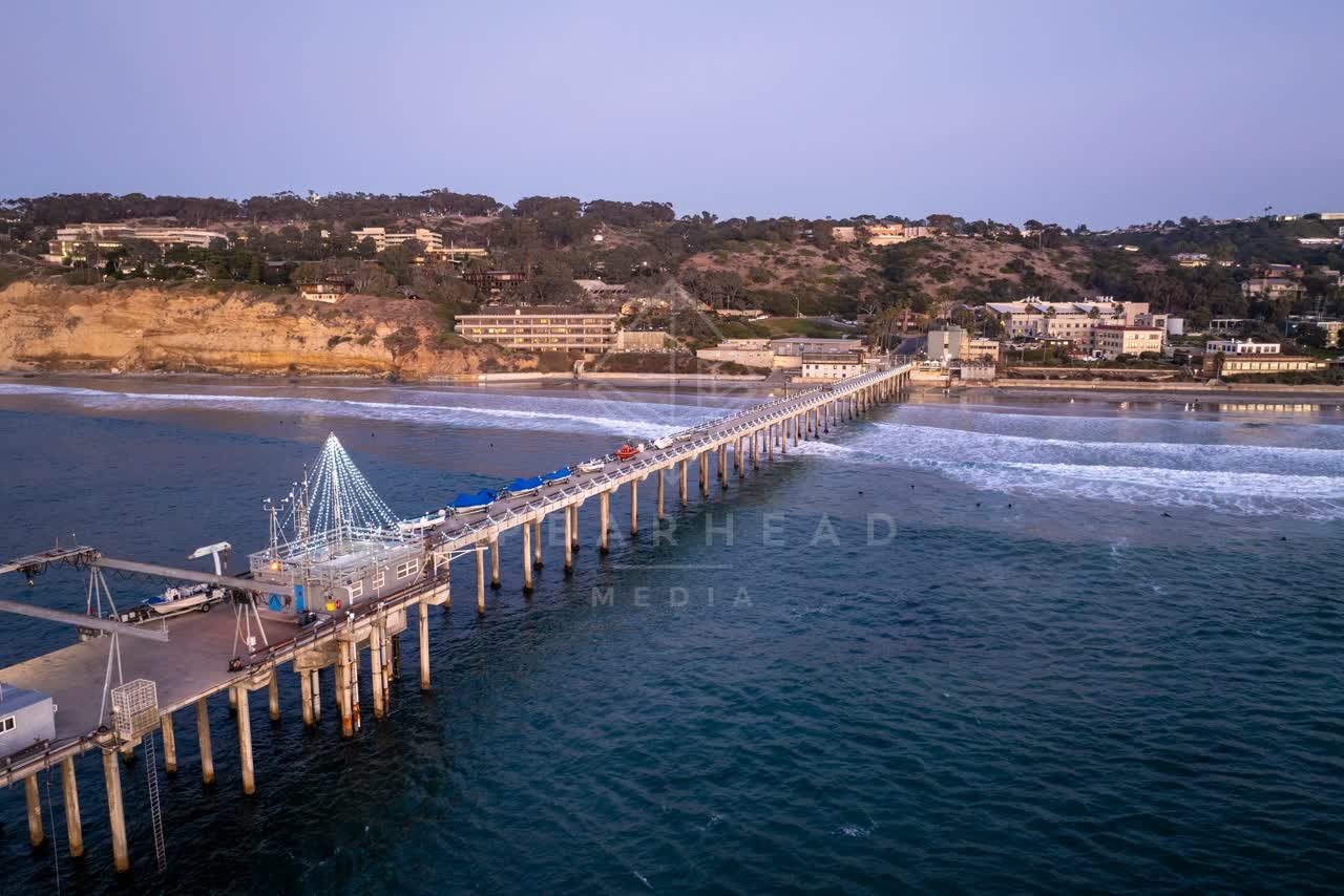 Aerial view of the beach, the surf and the pier at La Jolla Shores.