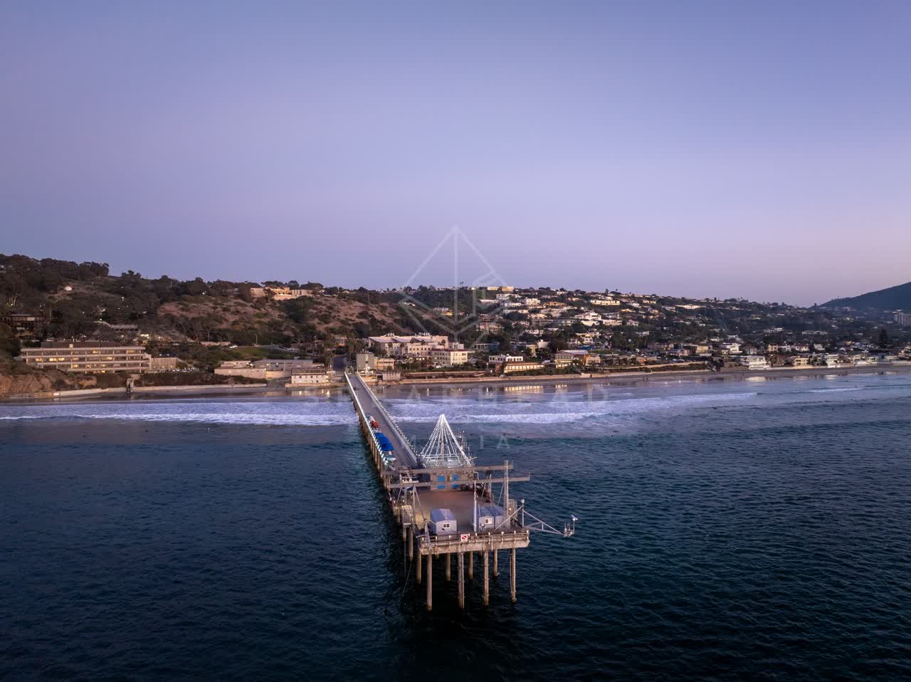Aerial view of the beach, the surf and the pier at La Jolla Shores.