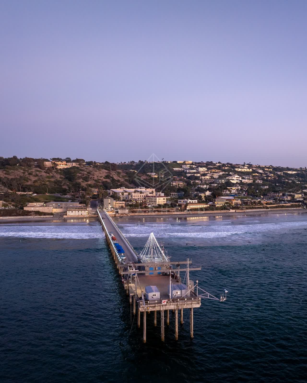 Aerial view of the beach, the surf and the pier at La Jolla Shores.