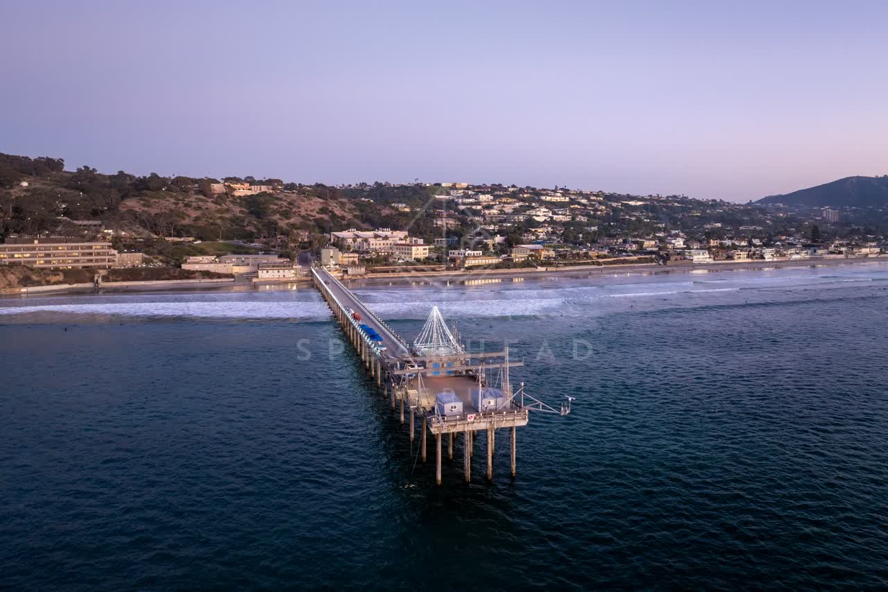 Aerial view of the beach, the surf and the pier at La Jolla Shores.