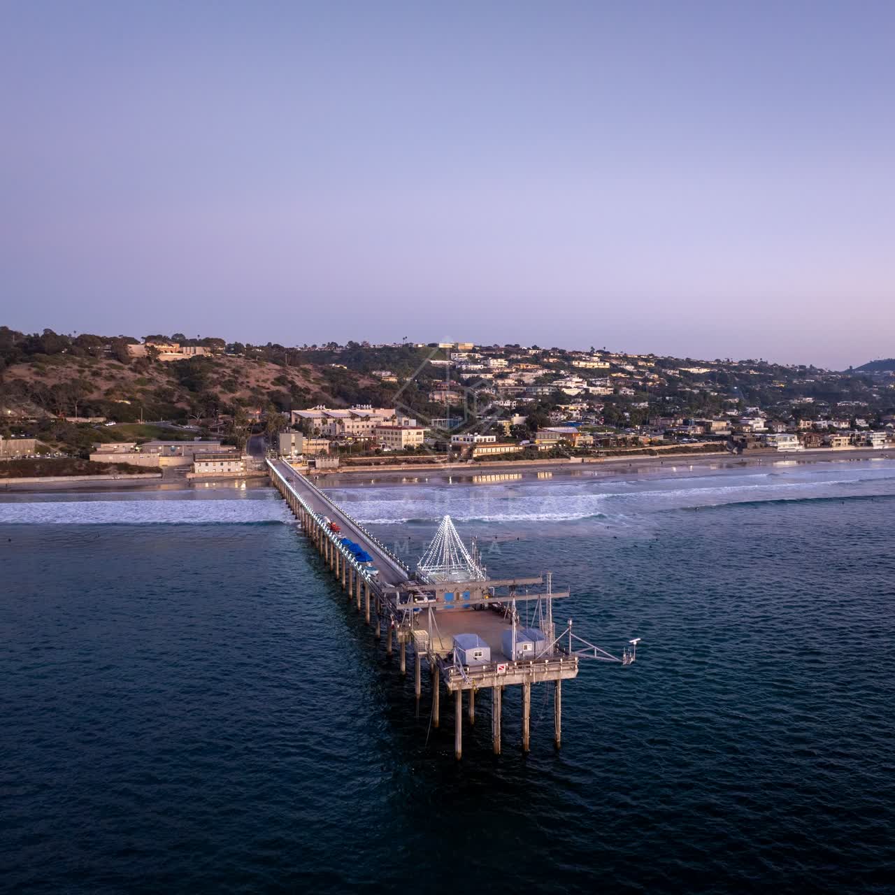 Aerial view of the beach, the surf and the pier at La Jolla Shores.