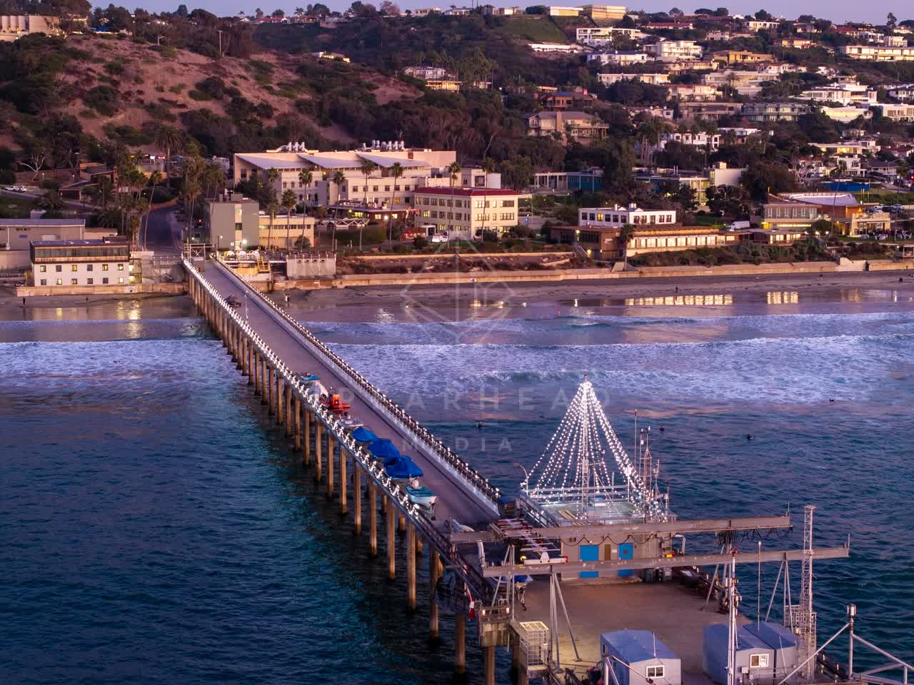Aerial view of the beach, the surf and the pier at La Jolla Shores.