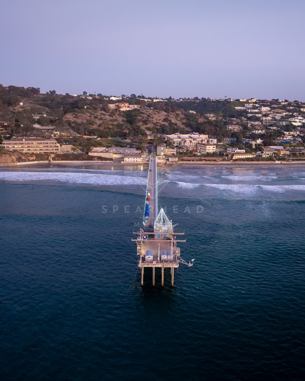 Aerial view of the beach, the surf and the pier at La Jolla Shores.