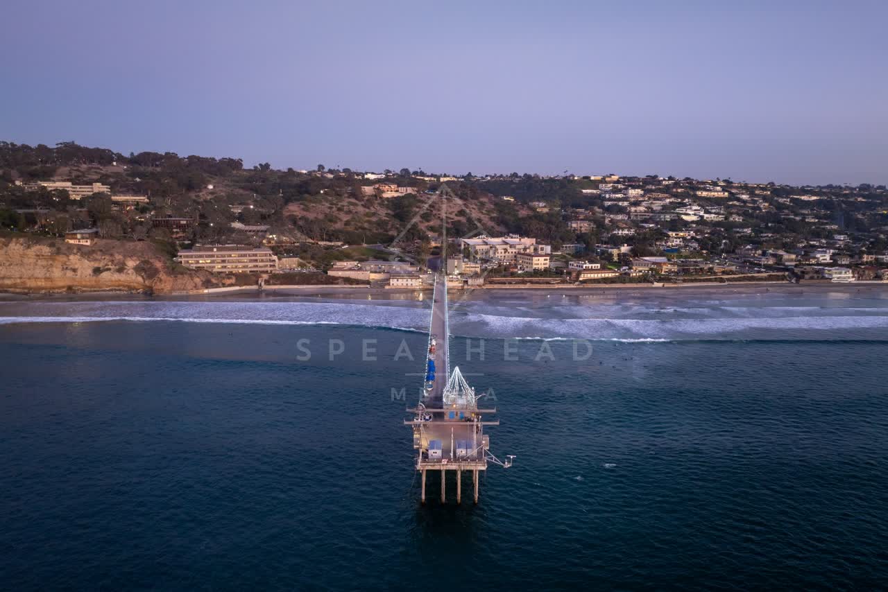 Aerial view of the beach, the surf and the pier at La Jolla Shores.