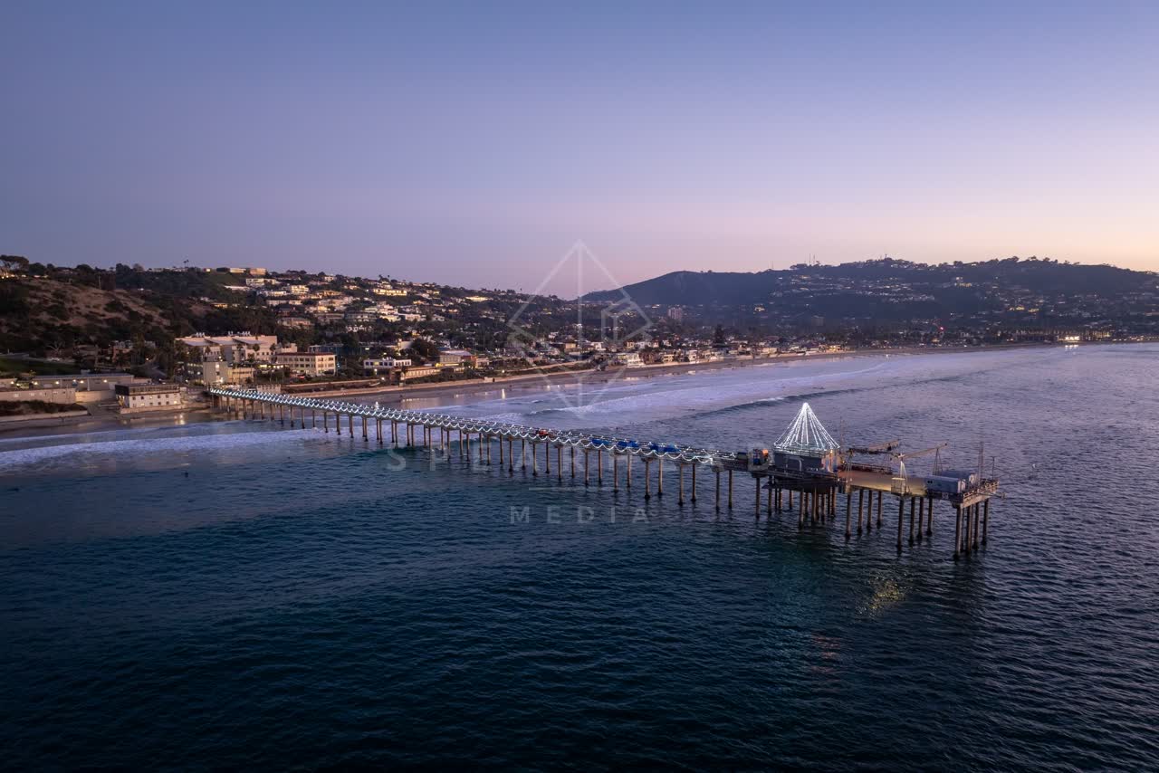 Aerial view of the beach, the surf and the pier at La Jolla Shores.