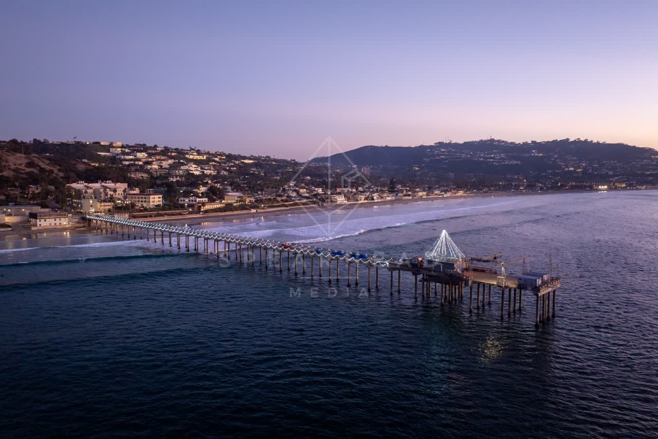 Aerial view of the beach, the surf and the pier at La Jolla Shores.