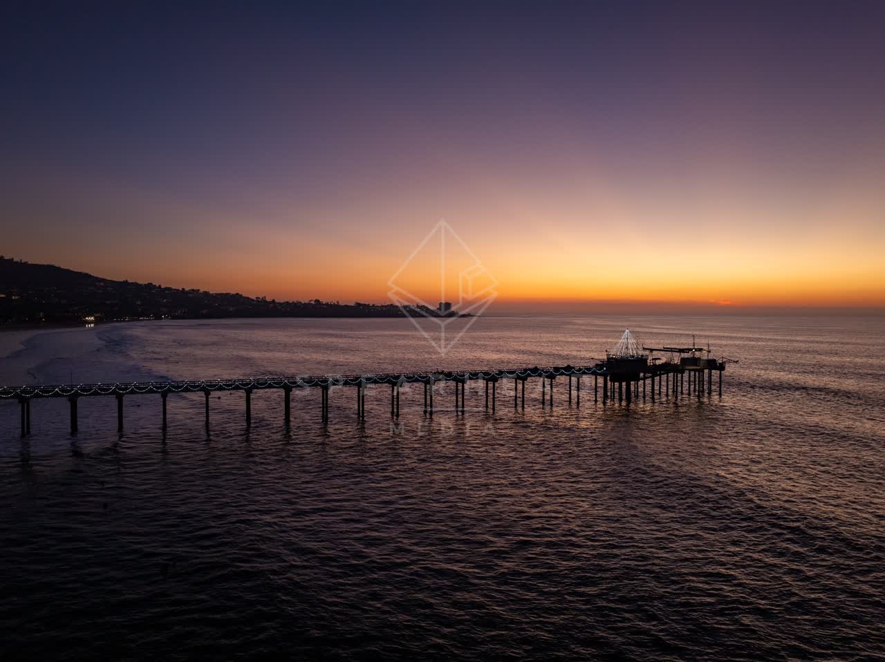 Low aerial view of the beach, the pier and the ocean at La Jolla Shores.