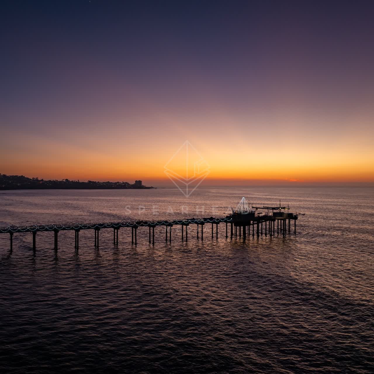 Low aerial view of the beach, the pier and the ocean at La Jolla Shores.
