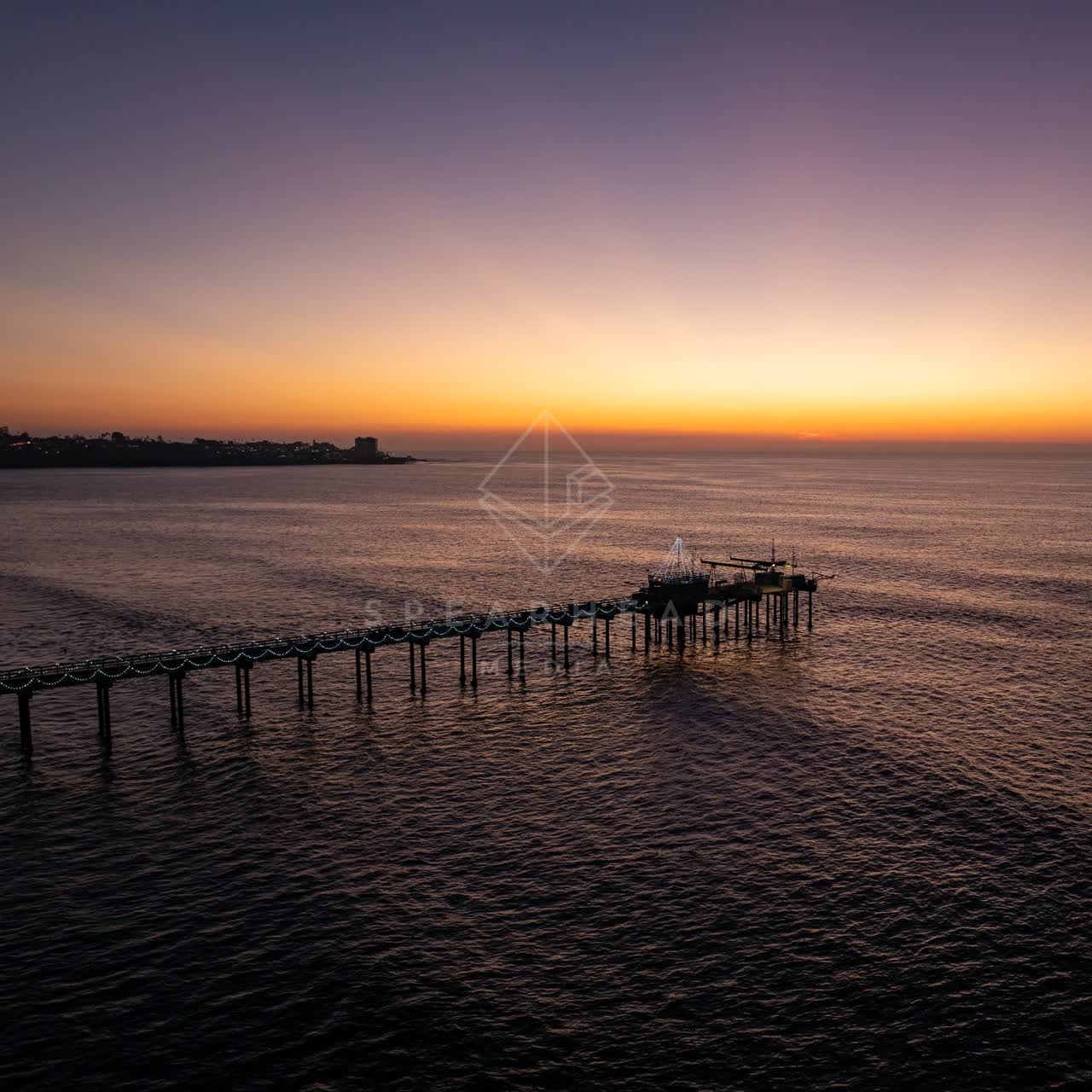 Low aerial view of the beach, the pier and the ocean at La Jolla Shores.