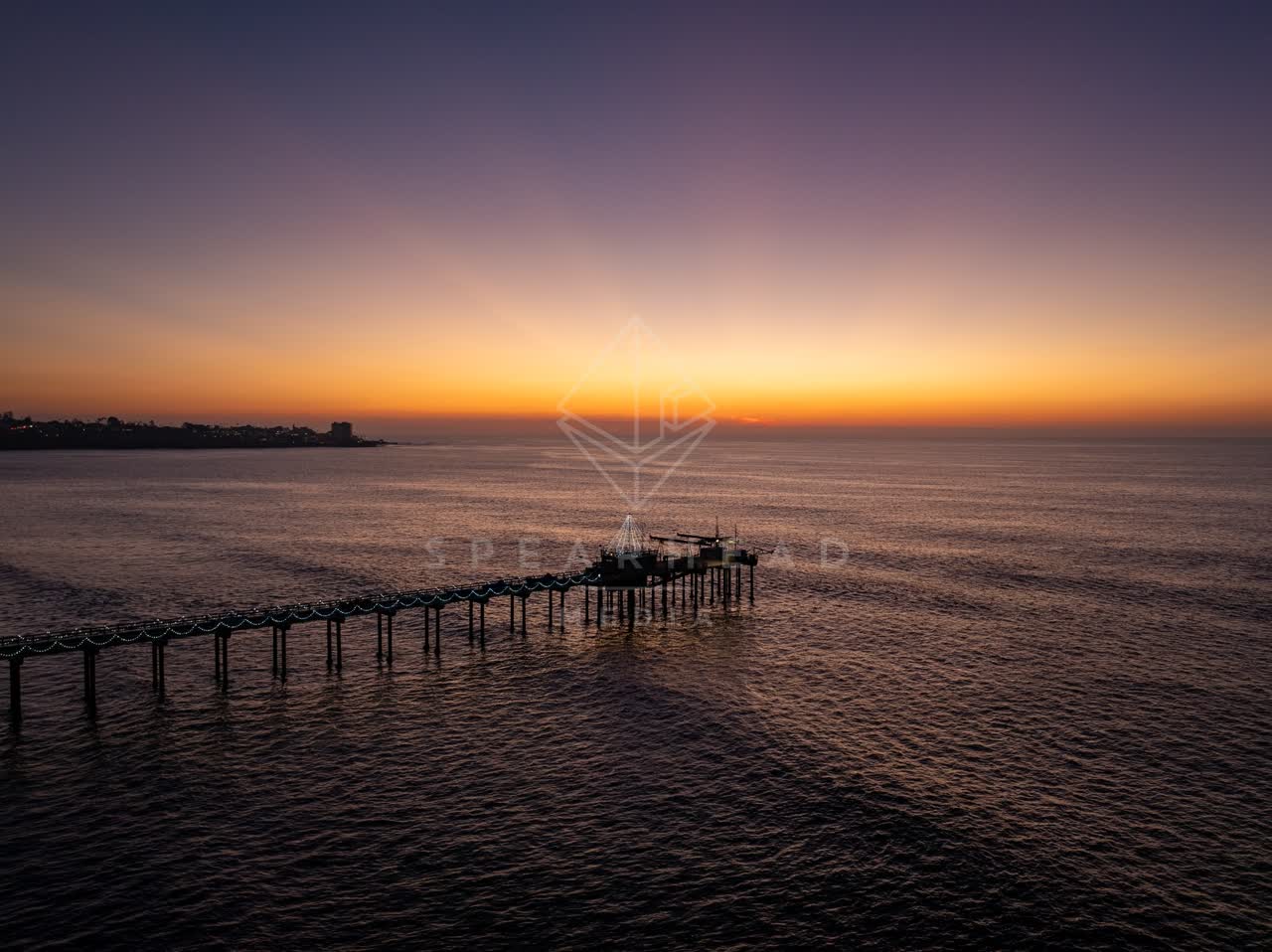 Low aerial view of the beach, the pier and the ocean at La Jolla Shores.